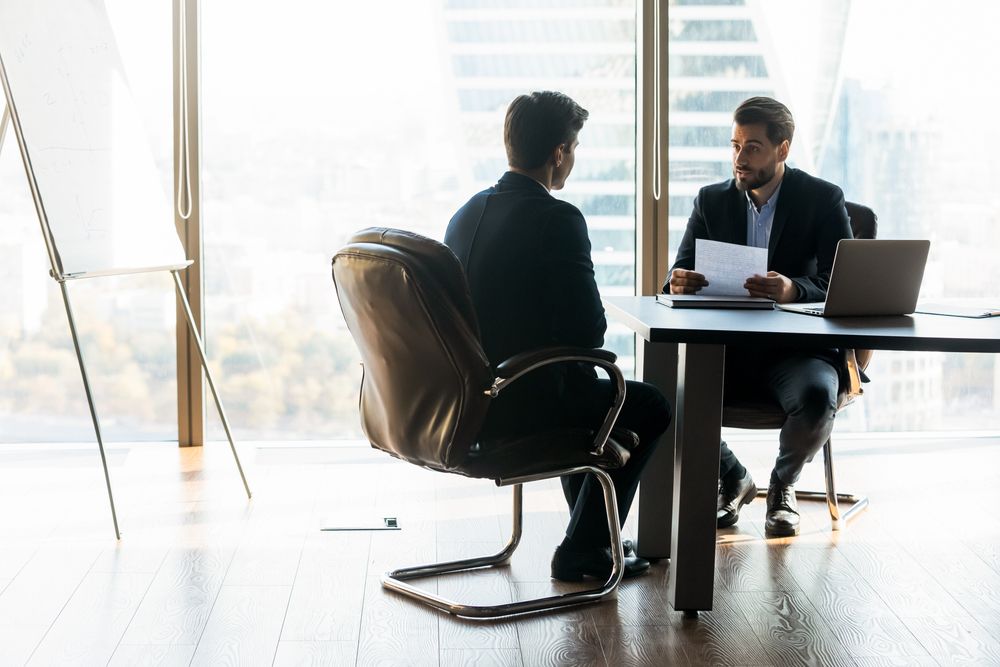 two businesspeople talking in office