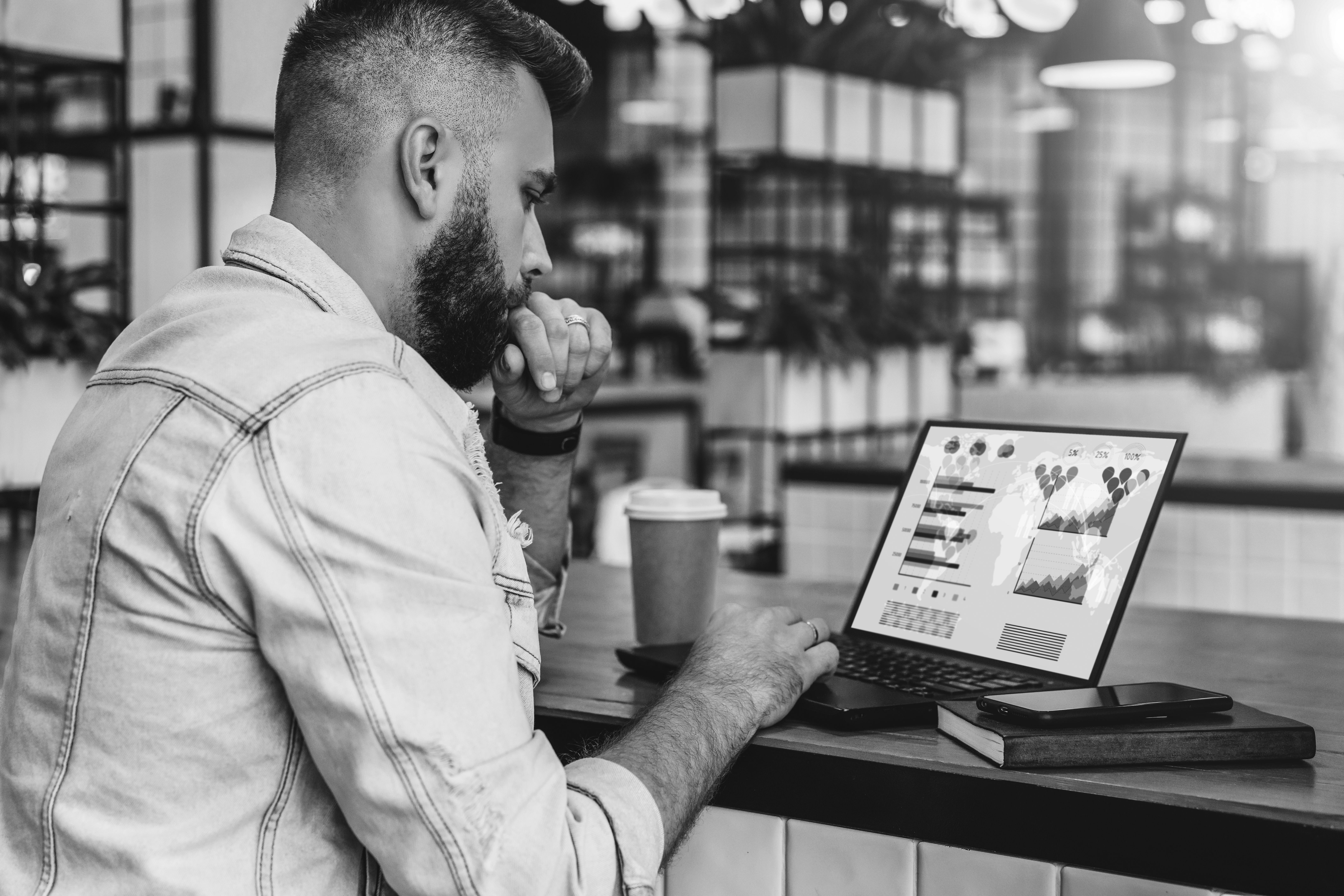 consultant working in coffee shop looking at charts